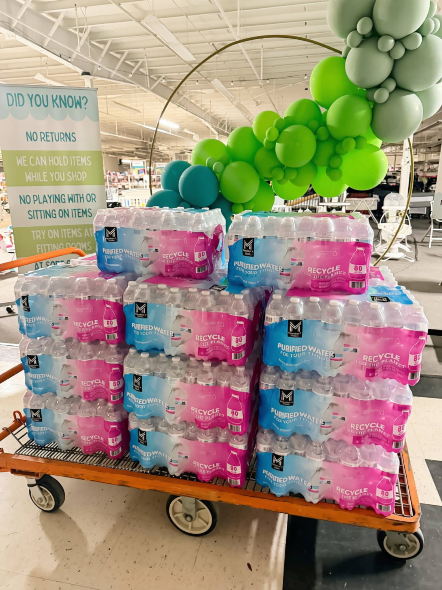 Cases of bottled water stacked on a cart inside our entrance